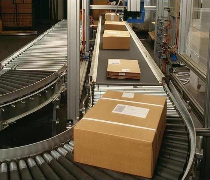 Industrial conveyor moving boxes.