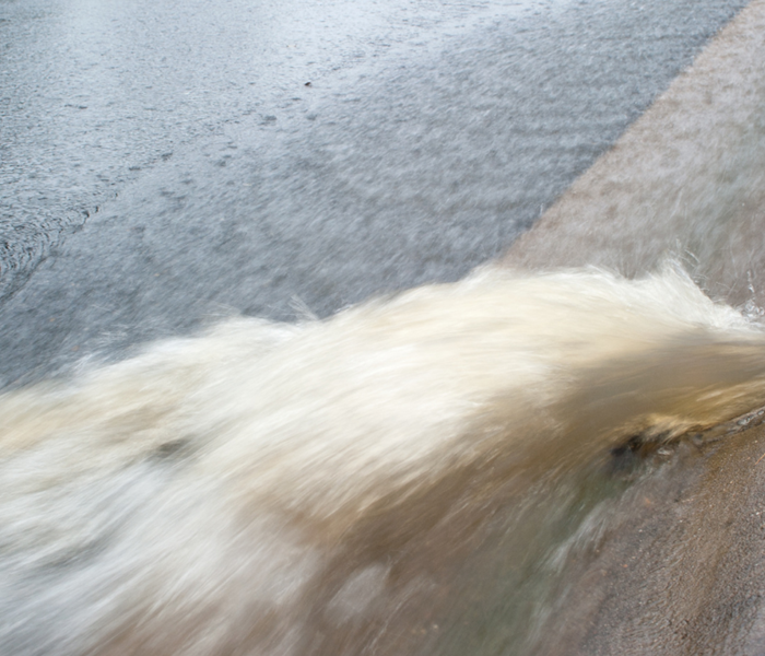 Storm water rushing in to street drain